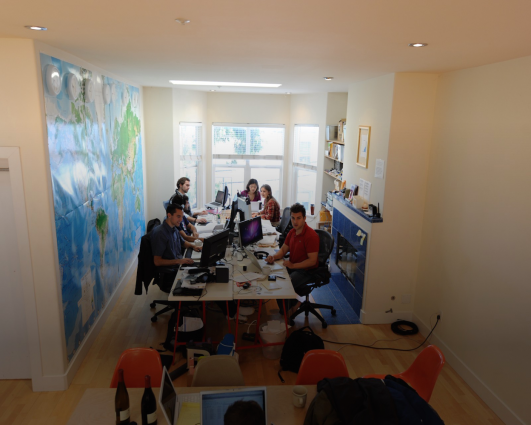 The early Airbnb team working from the co-founders' 3BR apartment complete with lofted ceilings, a bay window, hardwood floors, and a skylight. It's the giant world map that really makes it, though. Wonder how much it costs to rent it today?