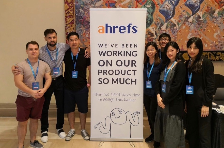 Photo of Ahrefs team and banner with rough sketches on it