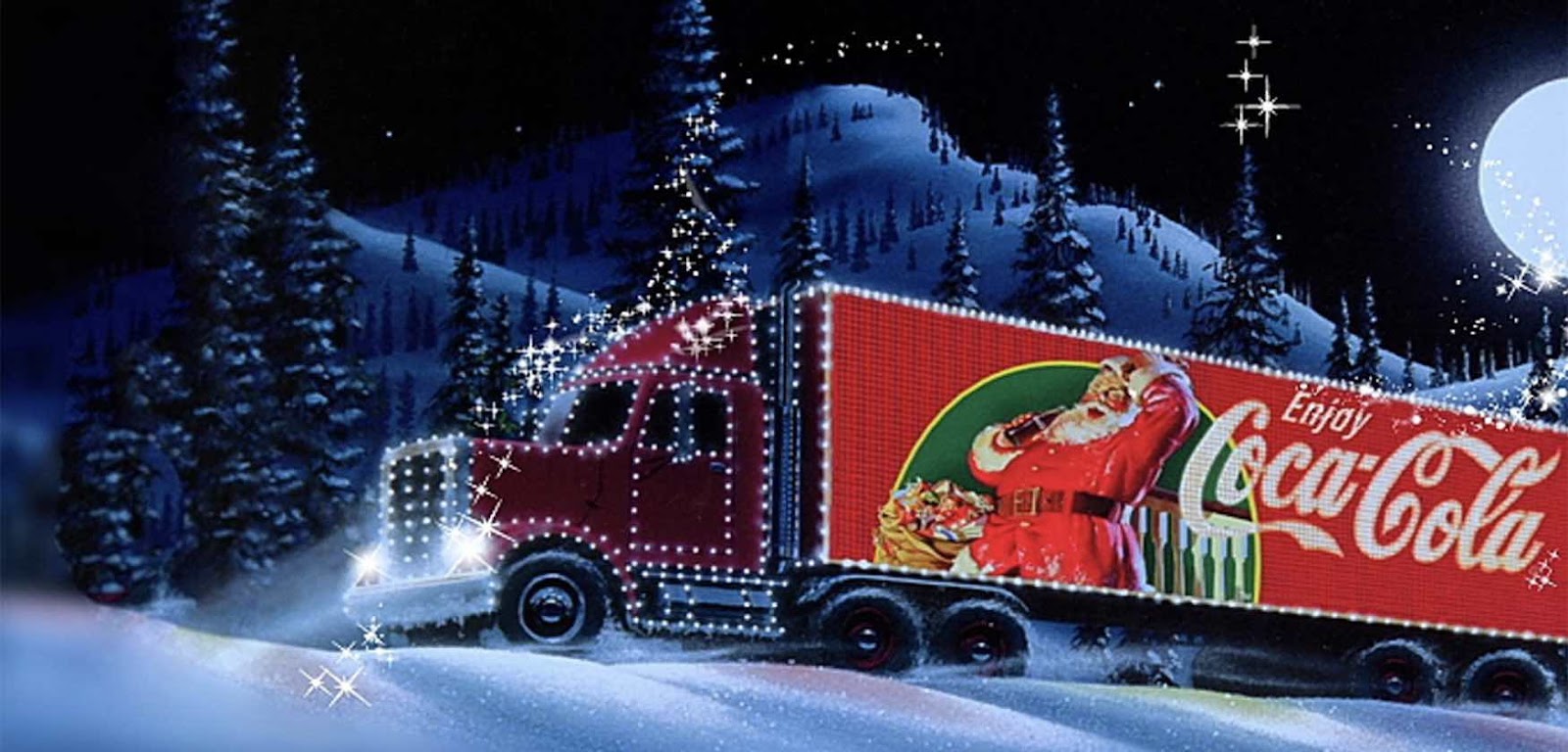 Red truck with picture of Santa Claus on it traveling through a snowy area 