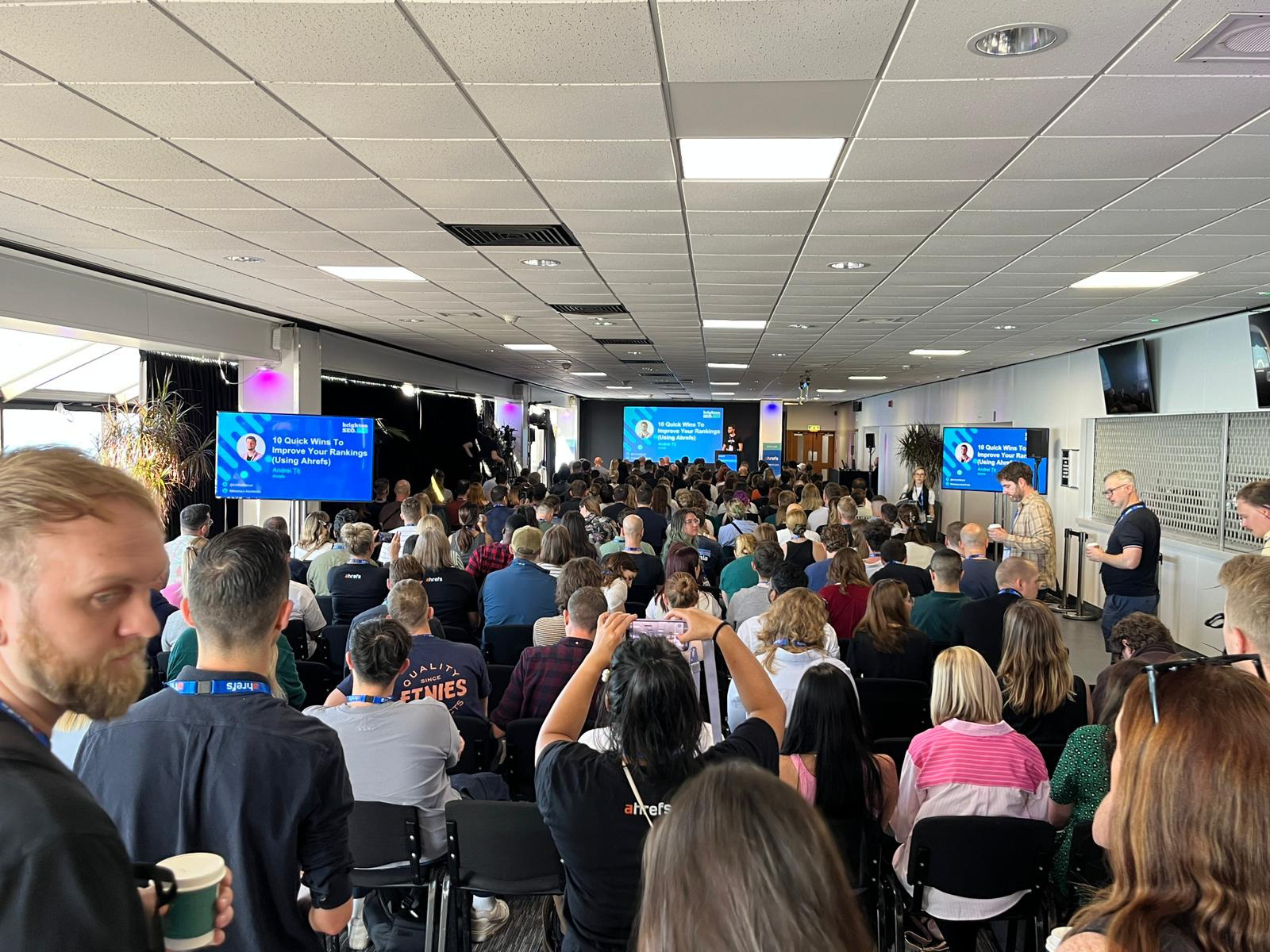 Andrei Țiț speaking in front of a crowd at BrightonSEO
