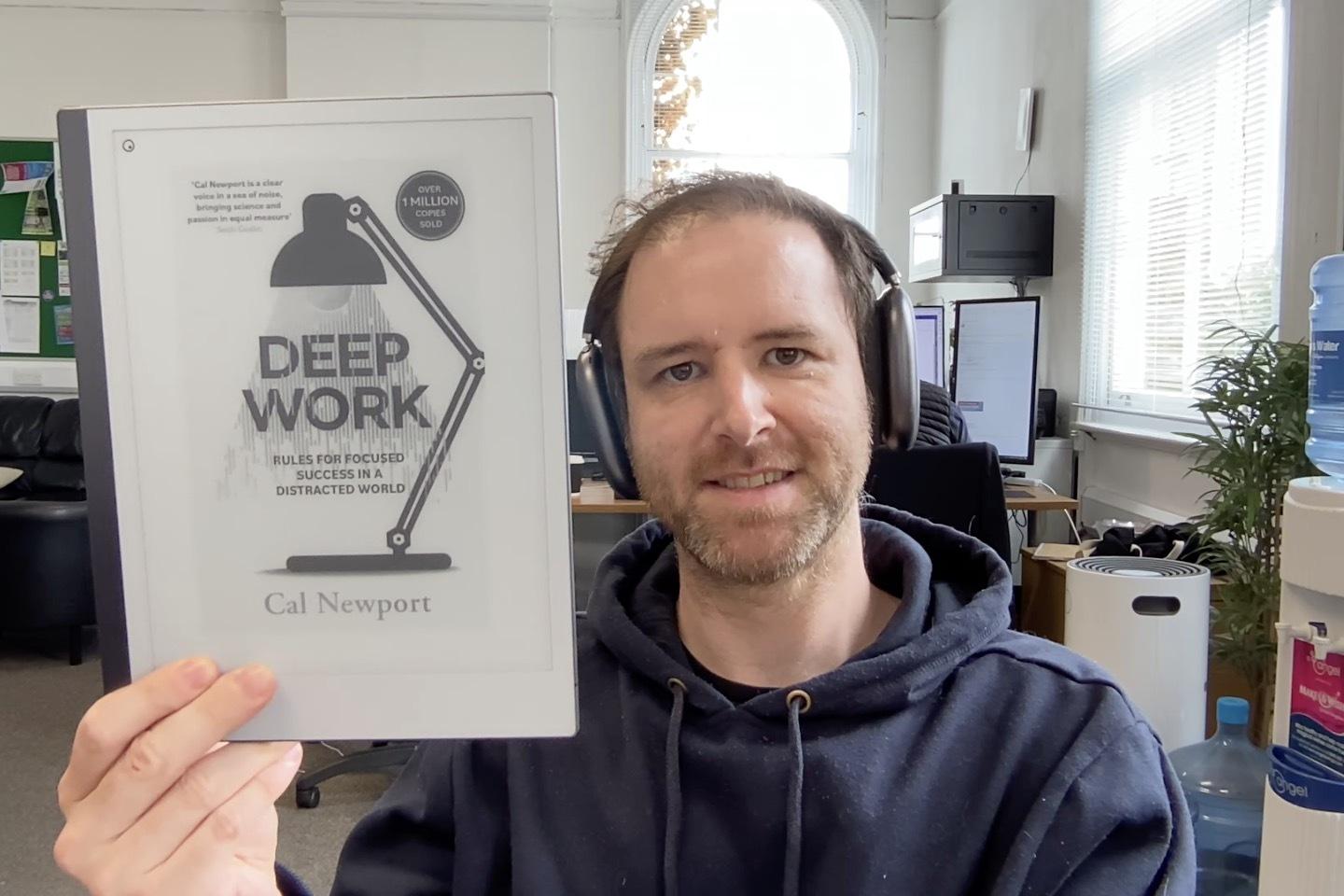 Chris holding the book Deep Work