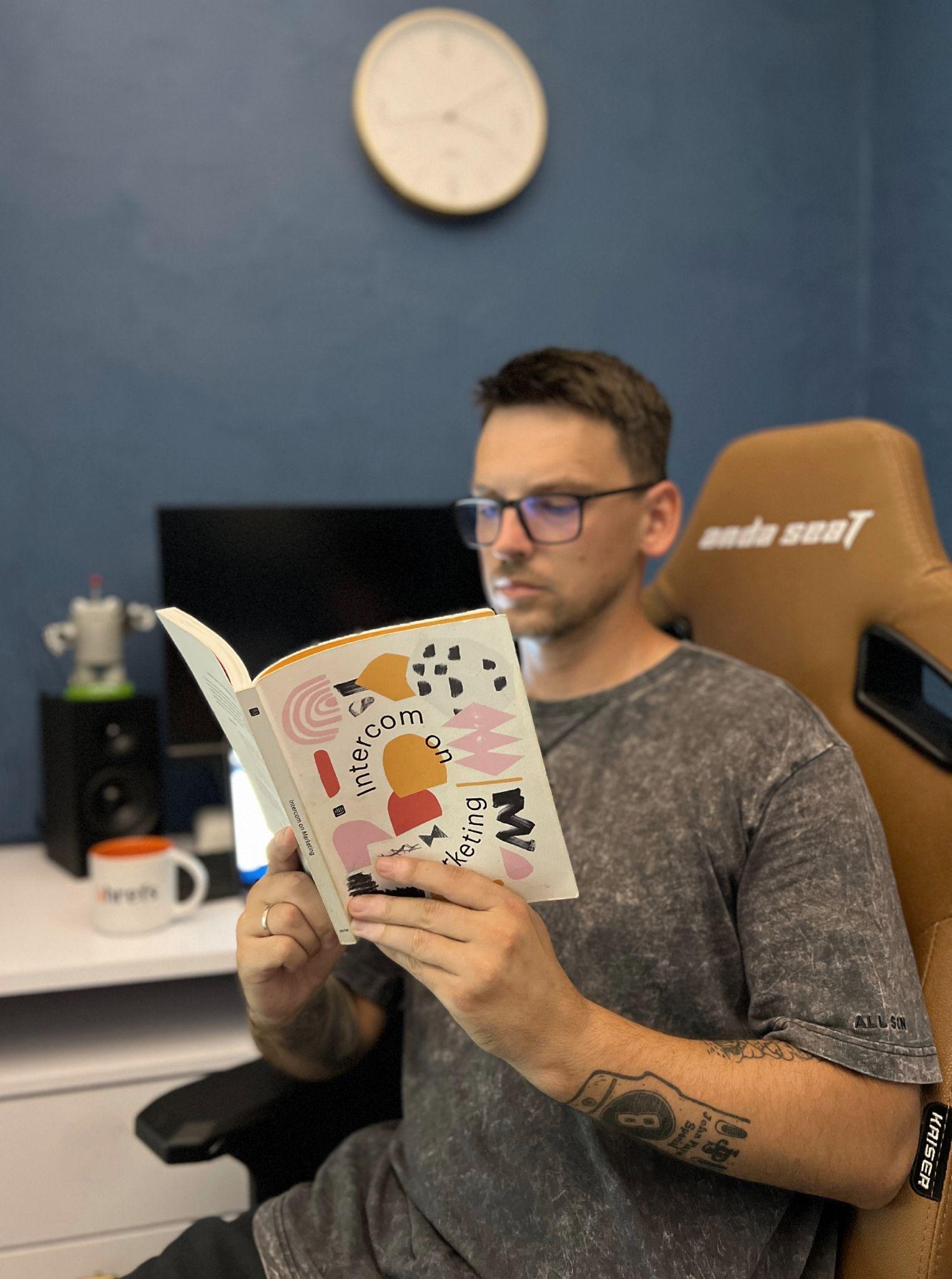 Igor holding the book Intercom on Marketing