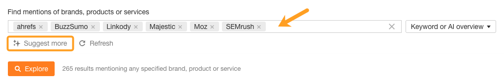 Search interface for brand mentions showing multiple SEO tools selected: ahrefs, BuzzSumo, Linkody, Majestic, Moz, and SEMrush, returning 265 results. Orange "Explore" button visible with "Suggest more" button circled.