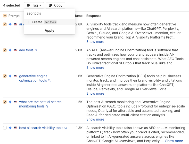 Tagging four selected prompts with a new "aeo tools" tag in a prompt list with AI responses and volumes
