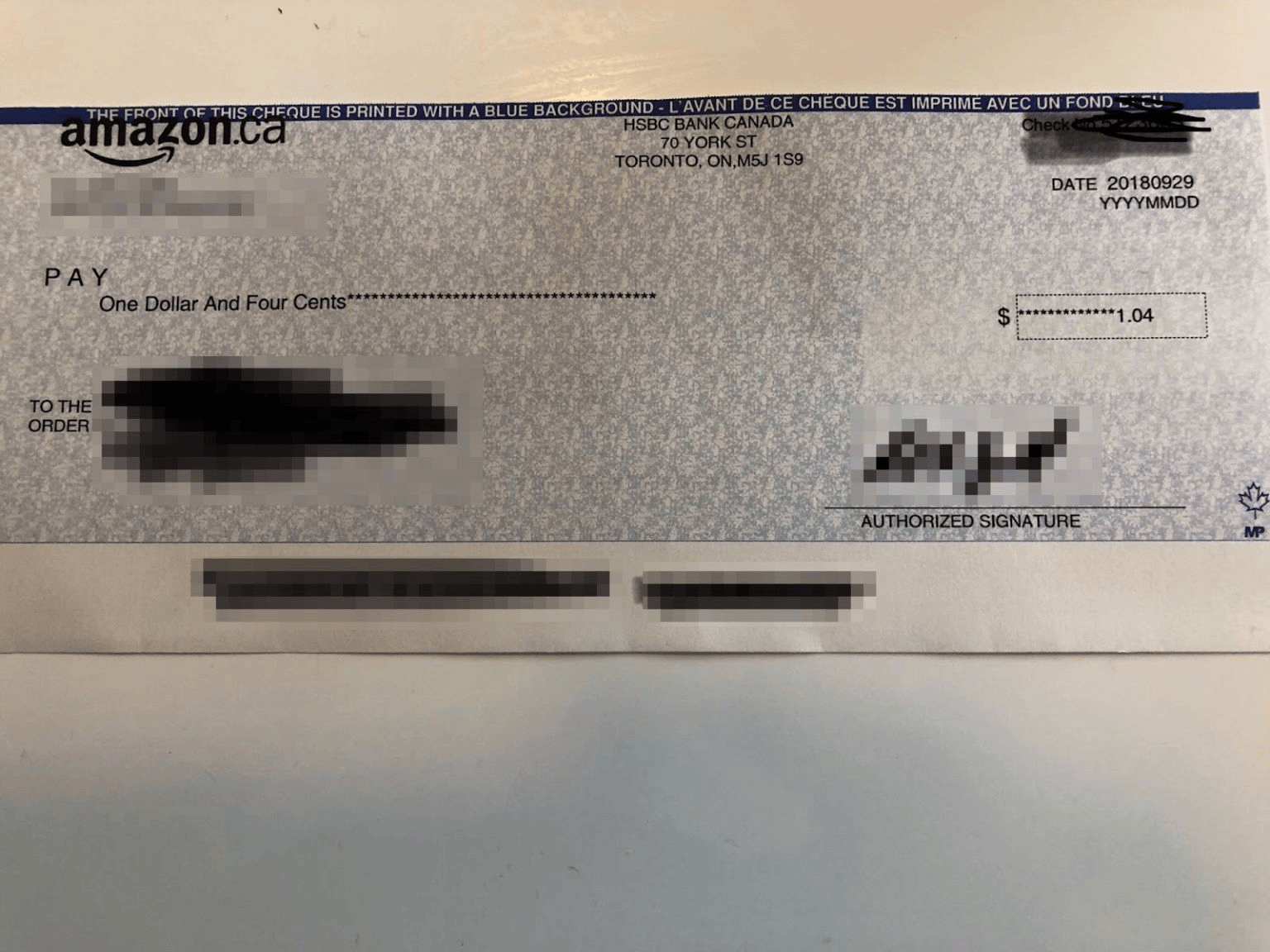 An Amazon.ca affiliate commission check dated September 29, 2018, made out for just $1.04, with personal details redacted.